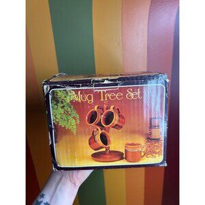 Vintage wooden tree and ceramic brown mugs drip glaze